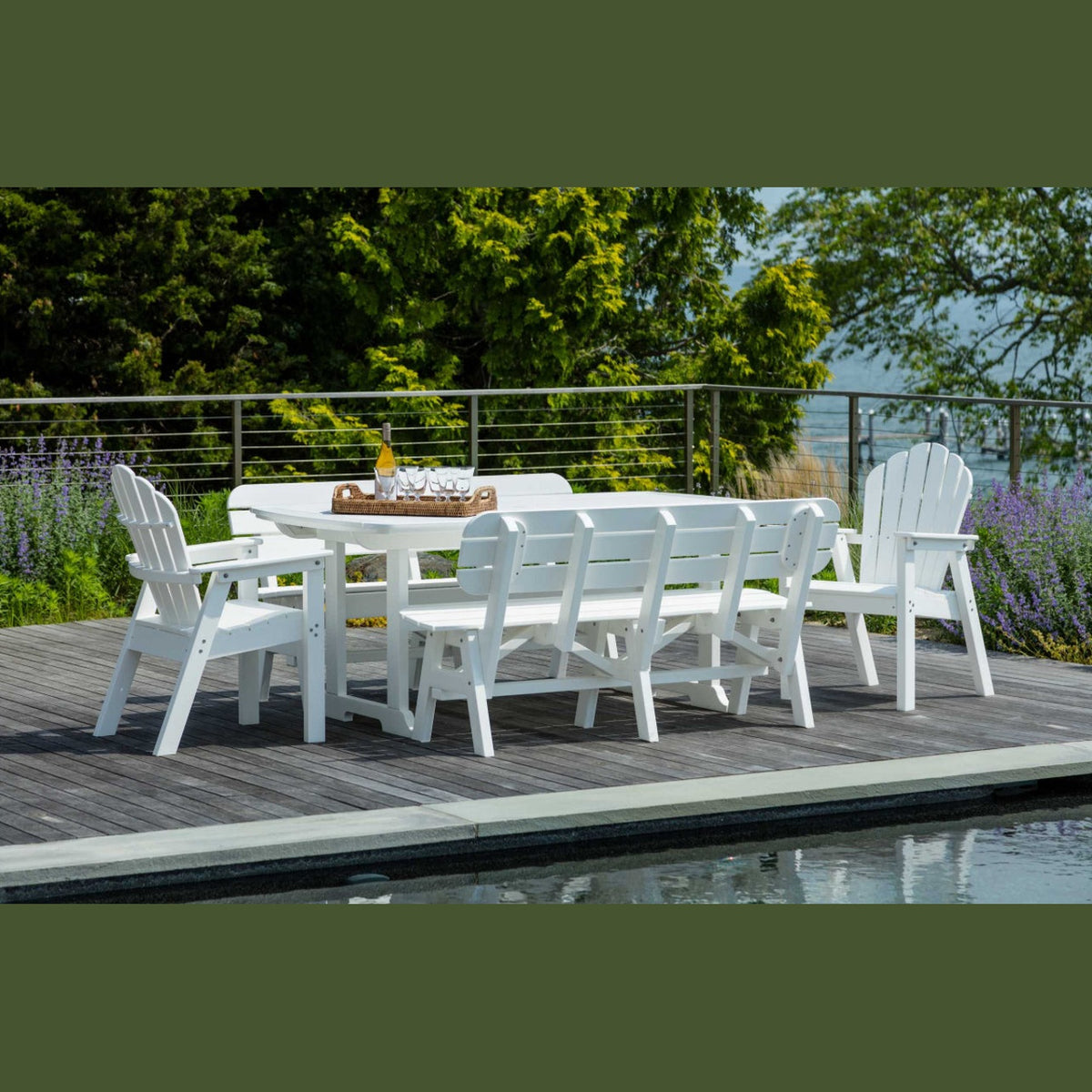 Outdoor dining set on a deck with a rectangular table, benches, and chairs, primarily in white color, with a scenic background.