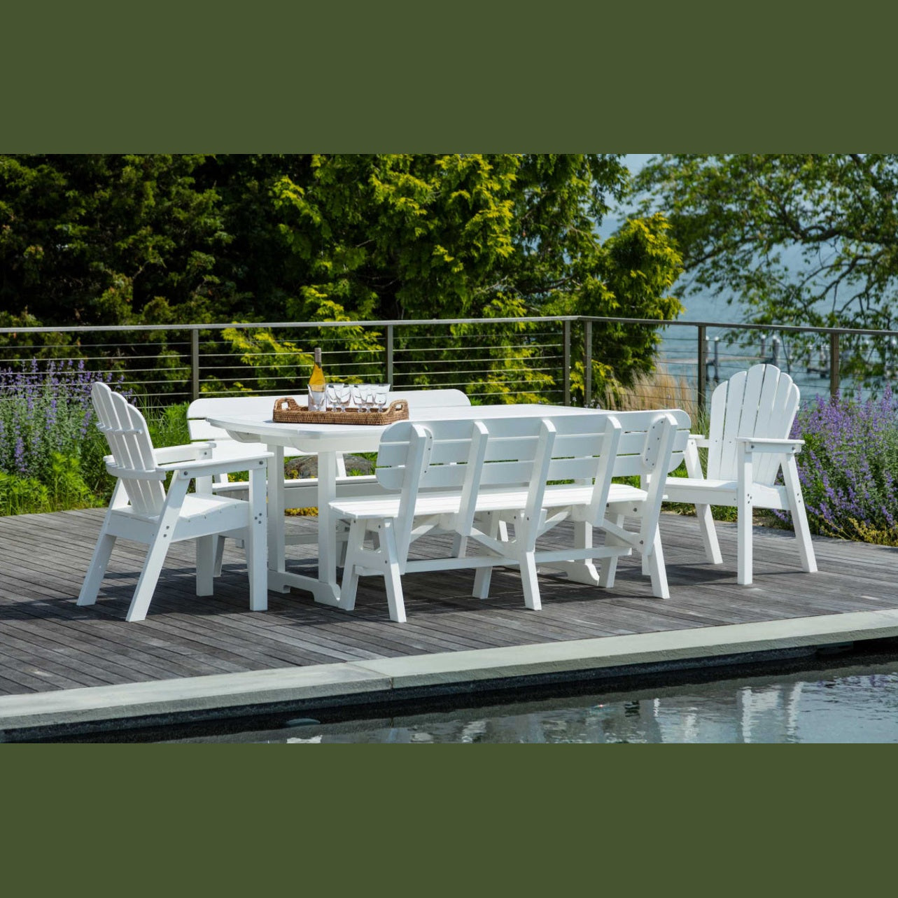 Outdoor dining set on a deck with a rectangular table, benches, and chairs, primarily in white color, with a scenic background.
