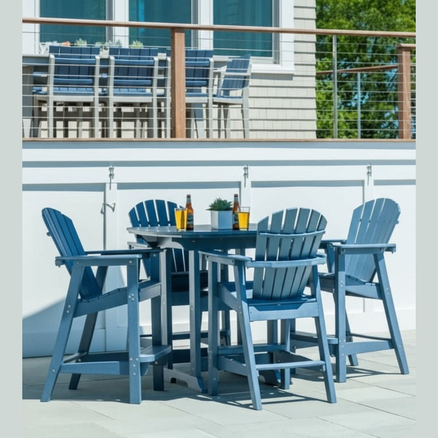 Outdoor bar height patio set with blue chairs and table on a deck.